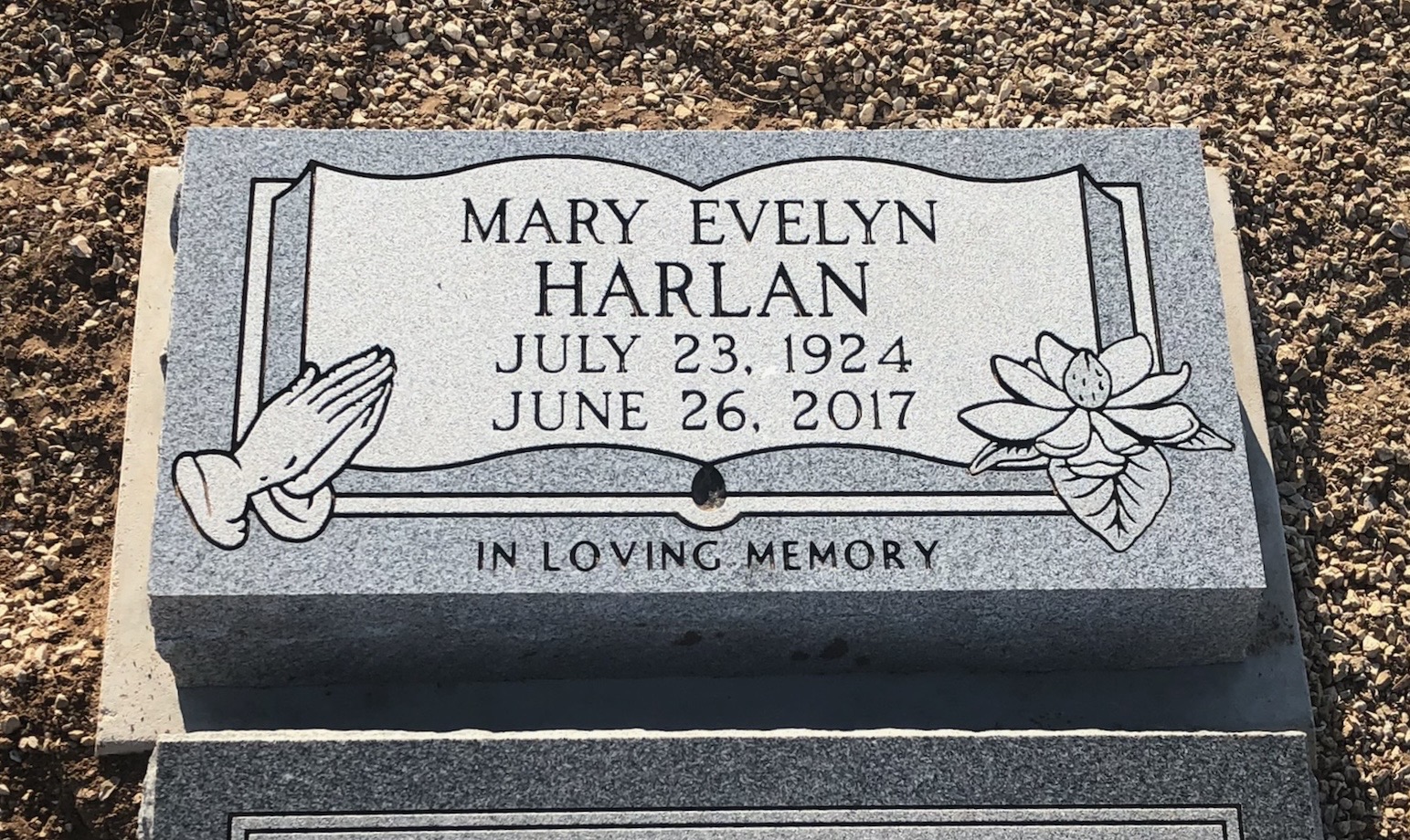Black granite flat headstone with laser-engraved design